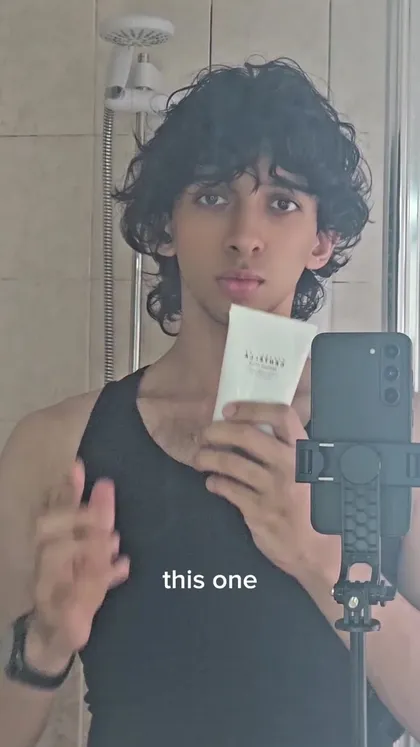 Talking about irritated skin from over-exfoliating, then applying Skin1004 in the bathroom mirror to calm it down.